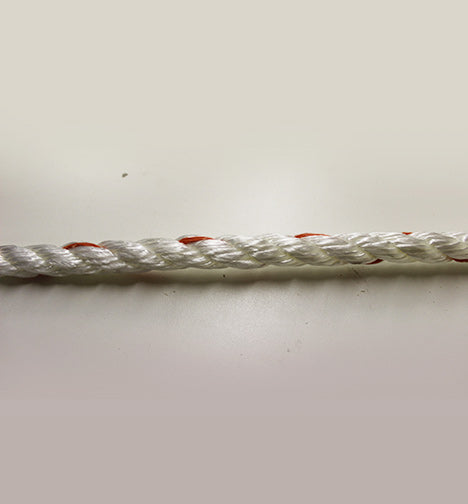 Close-up of a white 3-strand twisted rope with visible twisted strands and minor dirt.