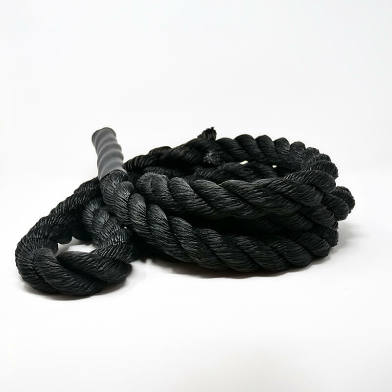 A coiled black climbing rope with a knot in the center, lying on a white background.