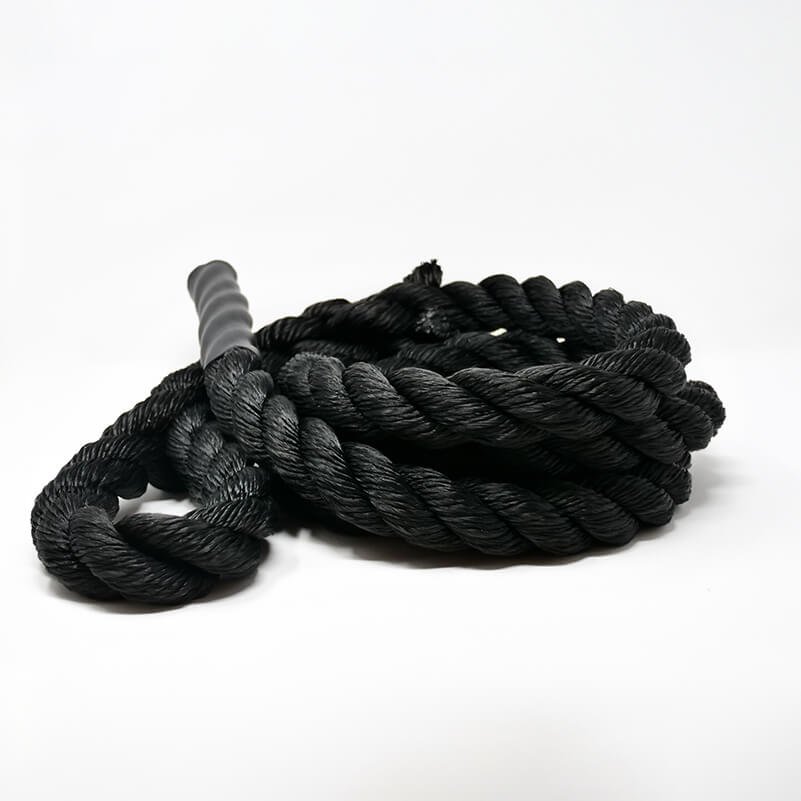 A coiled black climbing rope with a smooth texture on a white background.