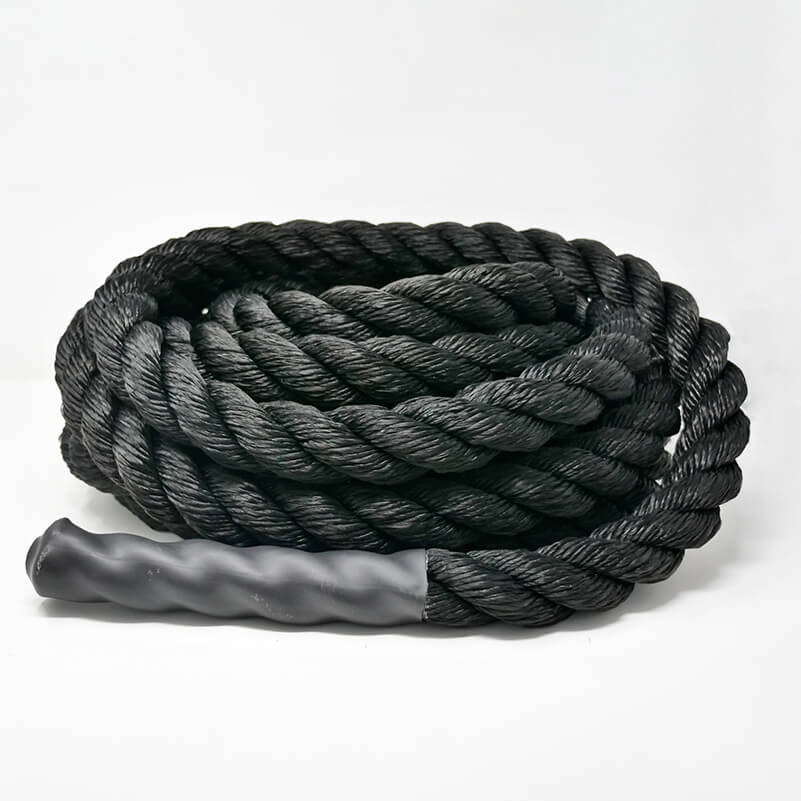 A coiled black battle rope made of nylon, designed for outdoor fitness exercises.