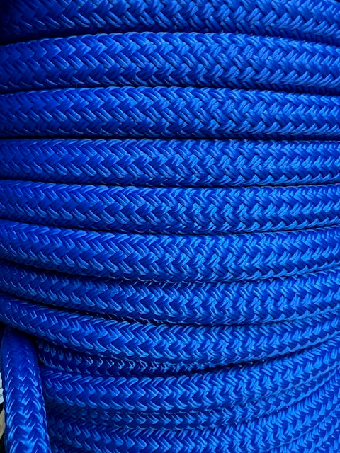 A close-up image of a royal blue double braid nylon rope coiled and secured with a rubber band.