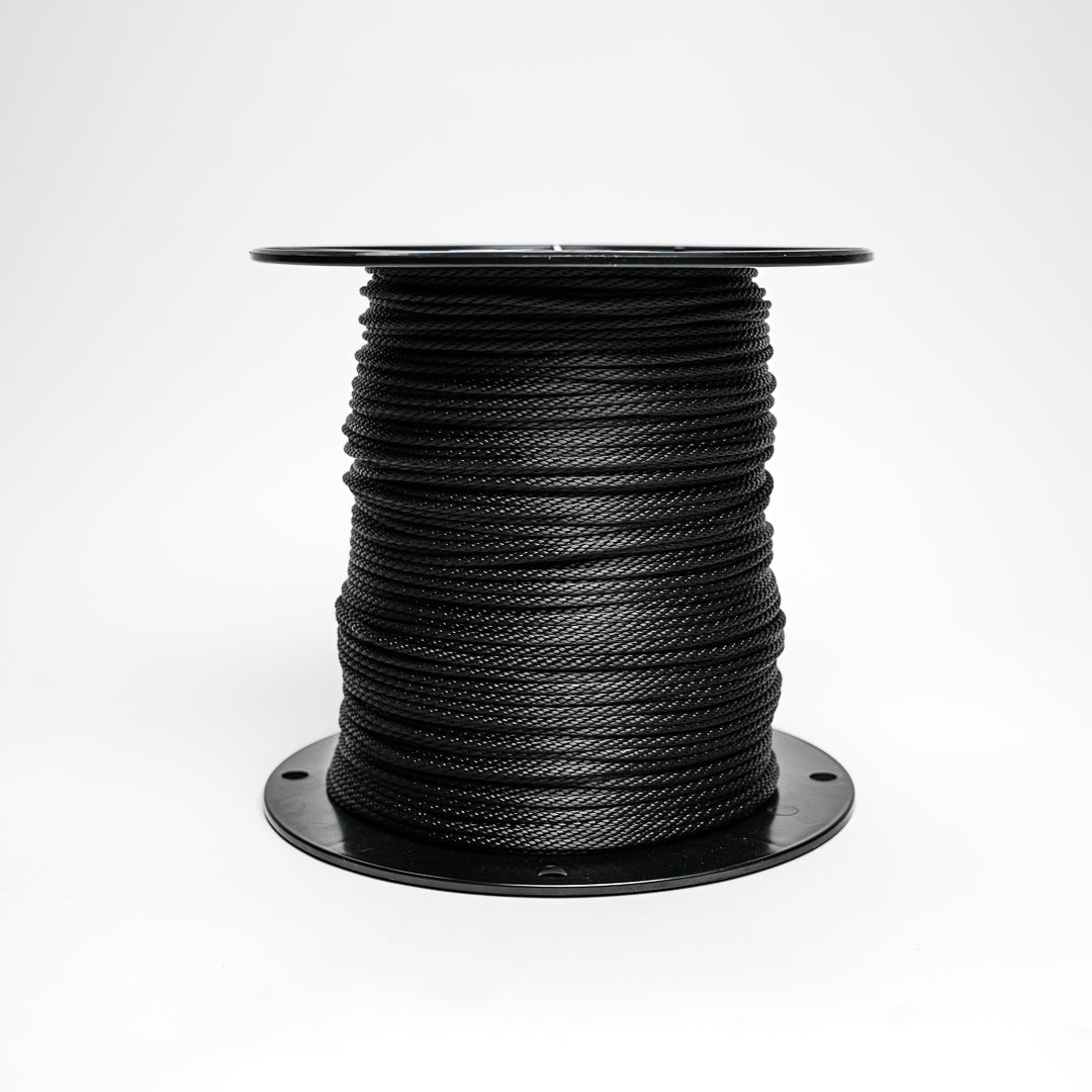 Spool of black rope on a white background