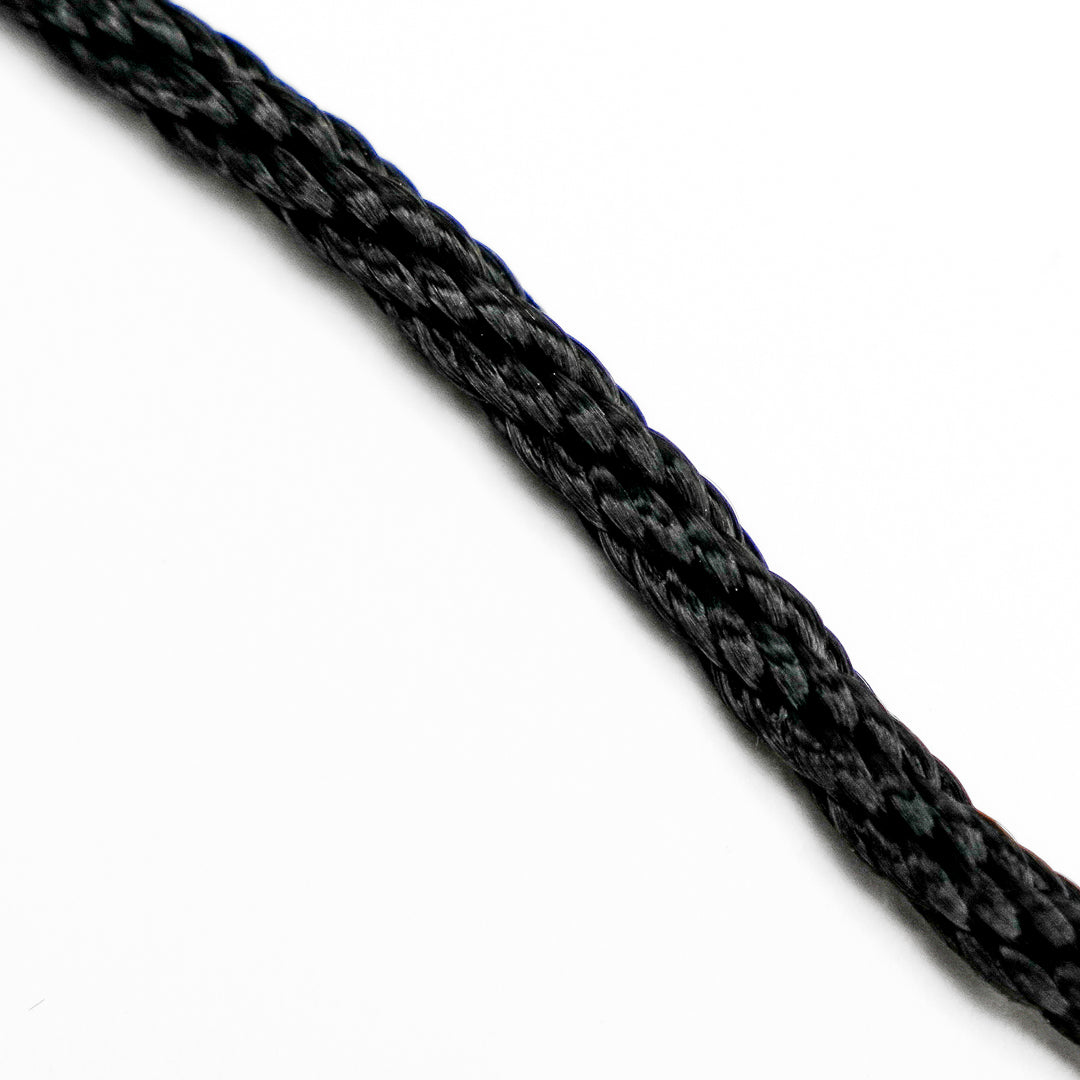 Close-up of a black braided rope on a white background