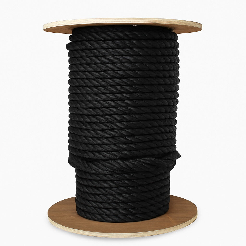 Spool of black rope on a wooden reel against a white background
